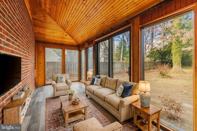 sunroom featuring lofted ceiling and wood ceiling