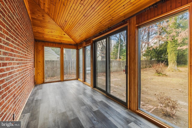 unfurnished sunroom featuring vaulted ceiling, plenty of natural light, and wood ceiling