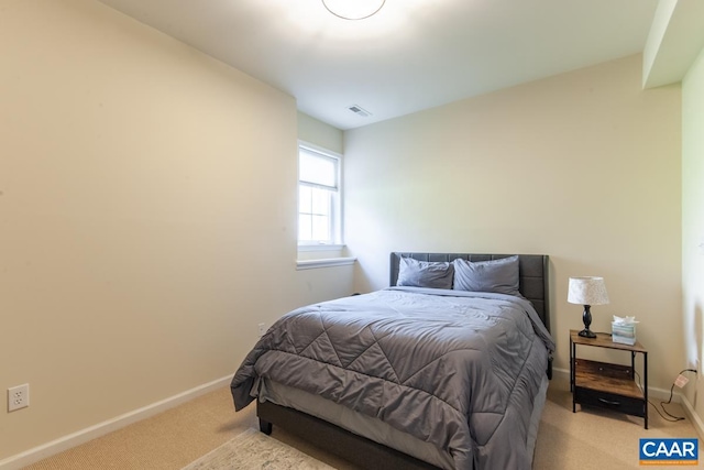 bedroom featuring light carpet