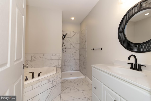 bathroom with vanity and independent shower and bath