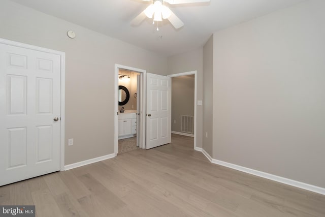 unfurnished bedroom featuring connected bathroom, ceiling fan, sink, and light hardwood / wood-style floors