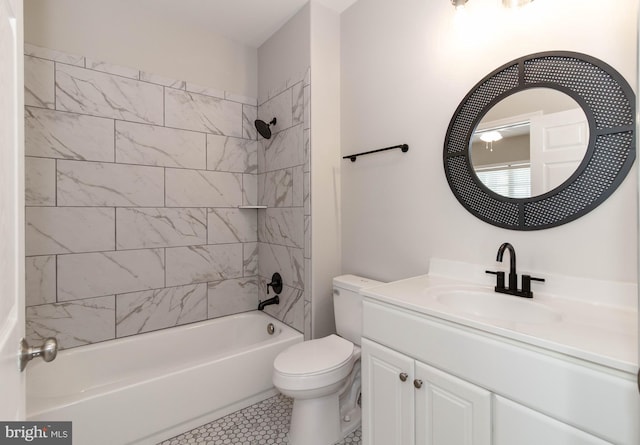 full bathroom featuring vanity, tiled shower / bath combo, and toilet