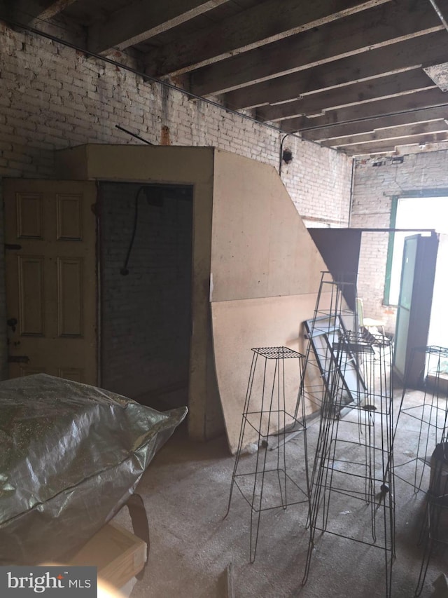 interior space with brick wall and concrete flooring