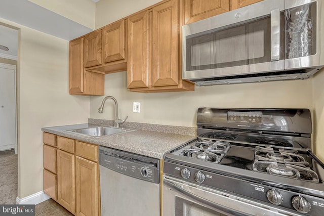 kitchen featuring light tile patterned flooring, stainless steel appliances, and sink