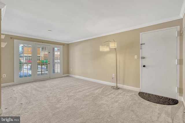 empty room with carpet, french doors, and ornamental molding