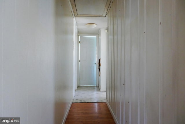 corridor with light hardwood / wood-style floors