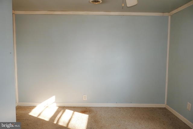 empty room featuring light colored carpet and crown molding