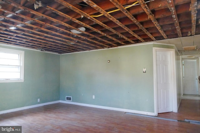 spare room featuring wood-type flooring