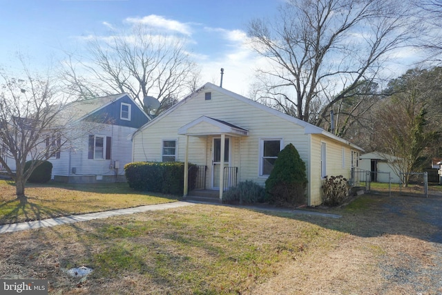 view of front of house with a front yard and a garage