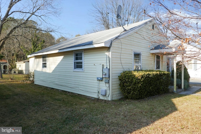 view of side of property with a lawn