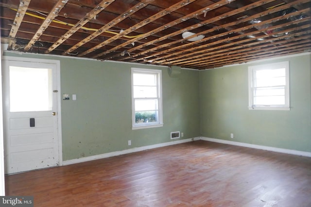 basement with hardwood / wood-style flooring