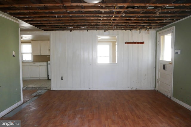 empty room with hardwood / wood-style floors and plenty of natural light