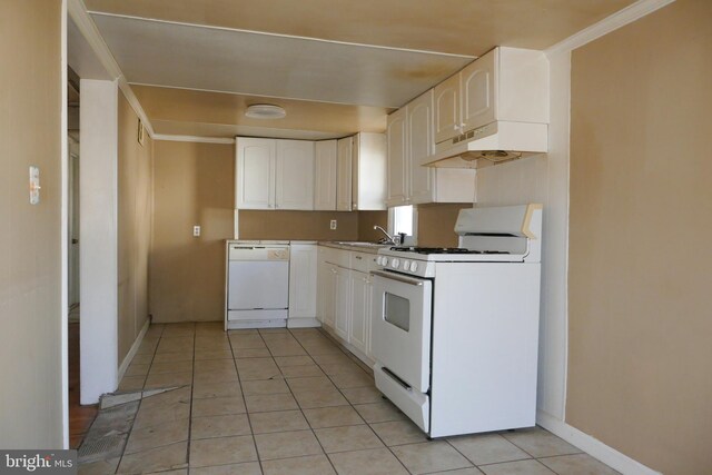 kitchen featuring white appliances, crown molding, sink, white cabinets, and light tile patterned flooring