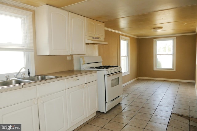 kitchen with wooden ceiling, sink, white gas range, light tile patterned flooring, and white cabinetry