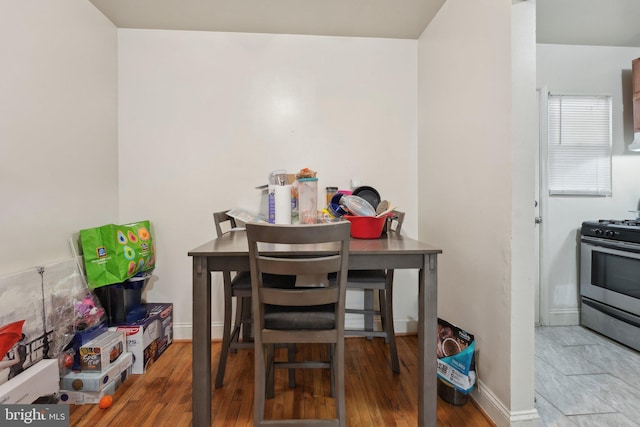 dining space with hardwood / wood-style floors