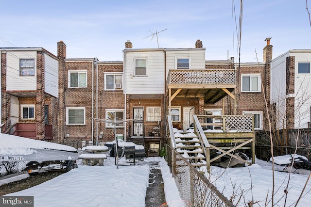 view of snow covered rear of property