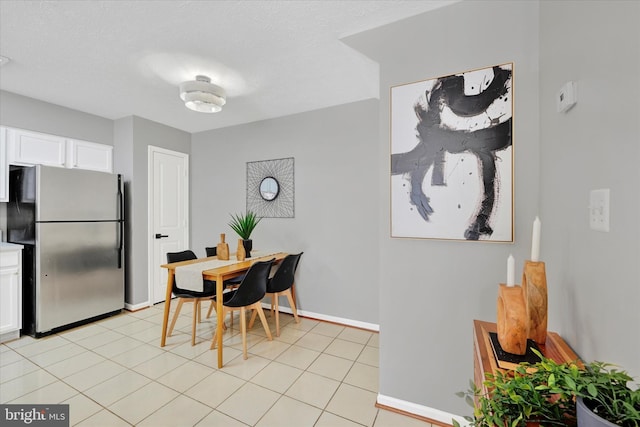 dining space featuring light tile patterned floors