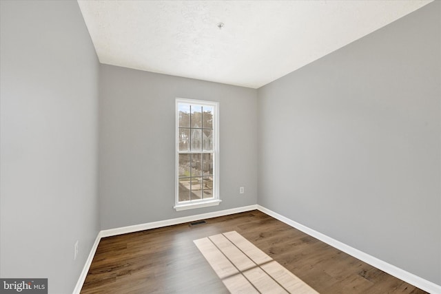 unfurnished room featuring dark hardwood / wood-style floors