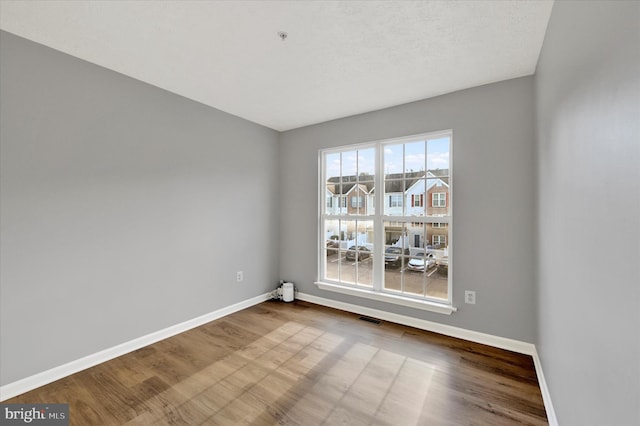 unfurnished room featuring hardwood / wood-style flooring