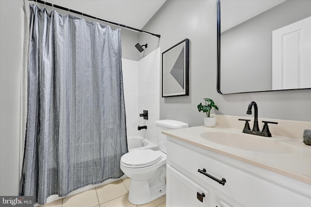 full bathroom with tile patterned floors, shower / bath combo with shower curtain, vanity, and toilet