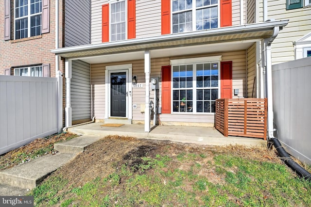 view of exterior entry with a porch