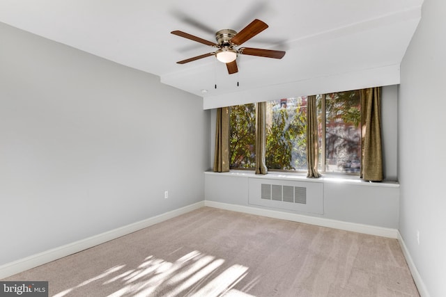 spare room featuring light carpet and ceiling fan