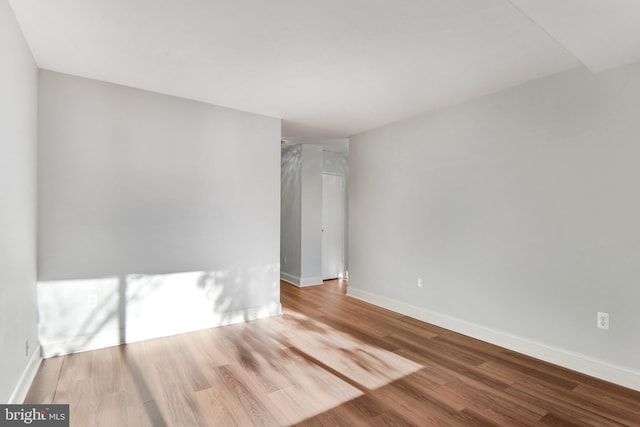 spare room with hardwood / wood-style floors