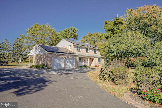 view of front of home featuring covered porch and a garage