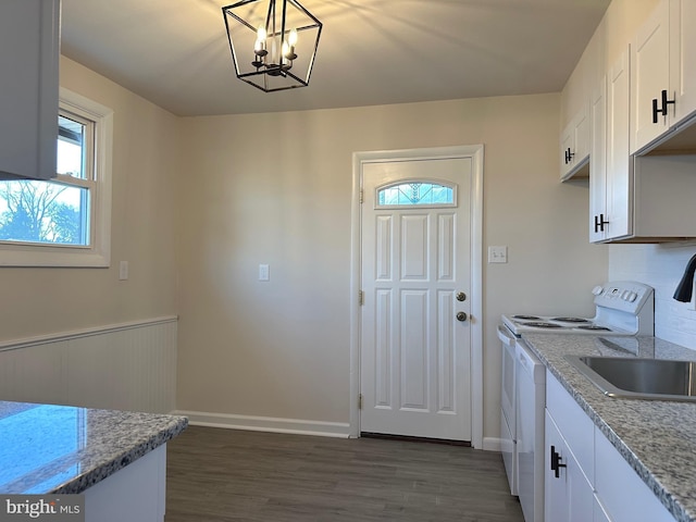 kitchen with white cabinets, pendant lighting, an inviting chandelier, and white electric stove