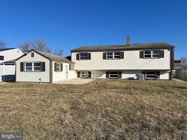 rear view of house featuring a yard, a patio, and central air condition unit