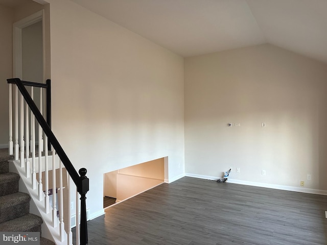 stairway featuring hardwood / wood-style floors and vaulted ceiling