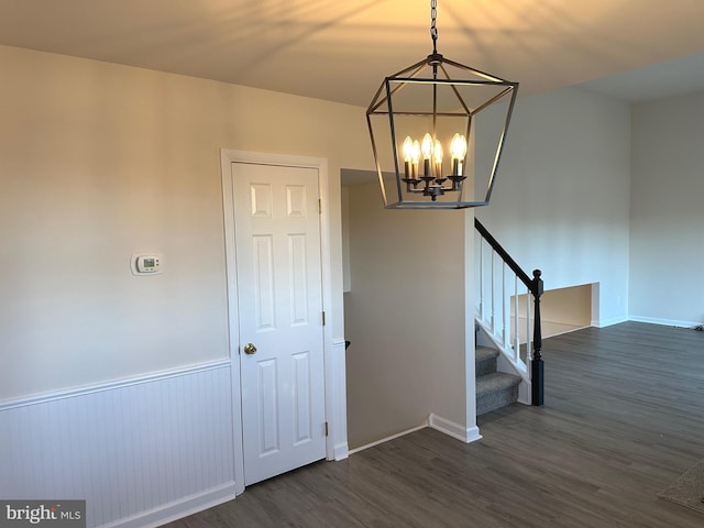 stairway featuring a chandelier and wood-type flooring