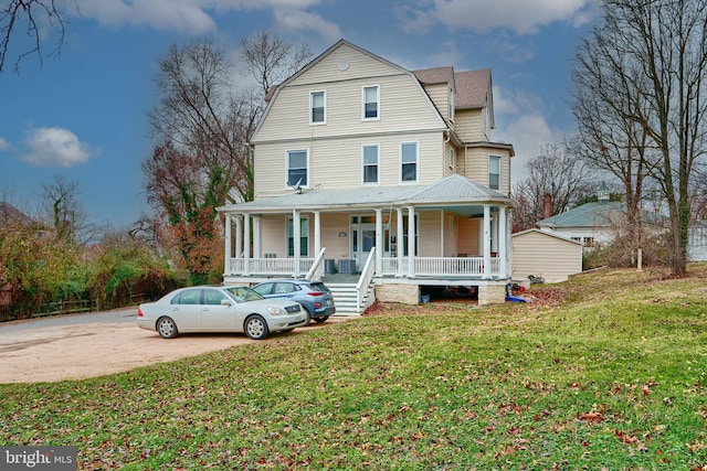 view of front of house with a porch and a front lawn