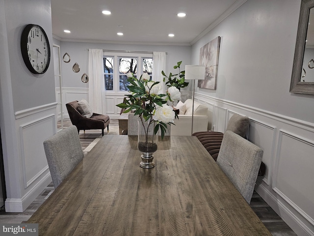 dining area with dark hardwood / wood-style flooring and ornamental molding