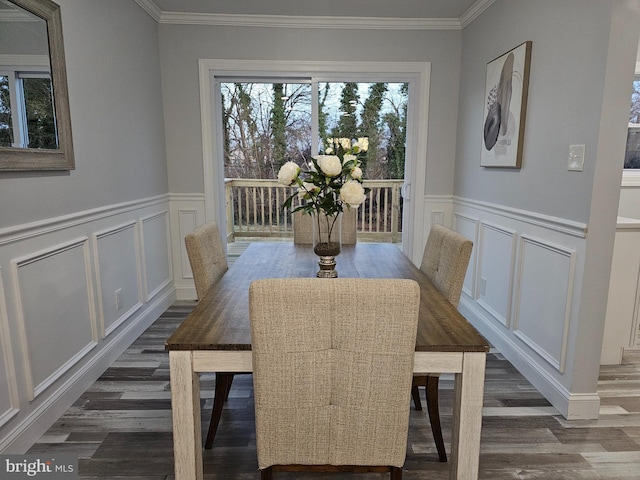 dining space featuring dark hardwood / wood-style floors and ornamental molding