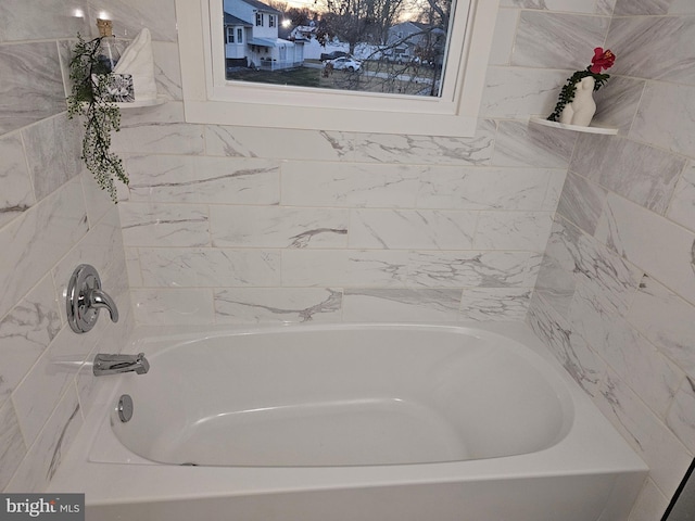 bathroom with a tub to relax in