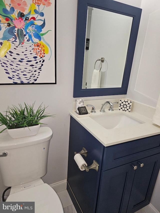 bathroom with tile patterned floors, vanity, and toilet