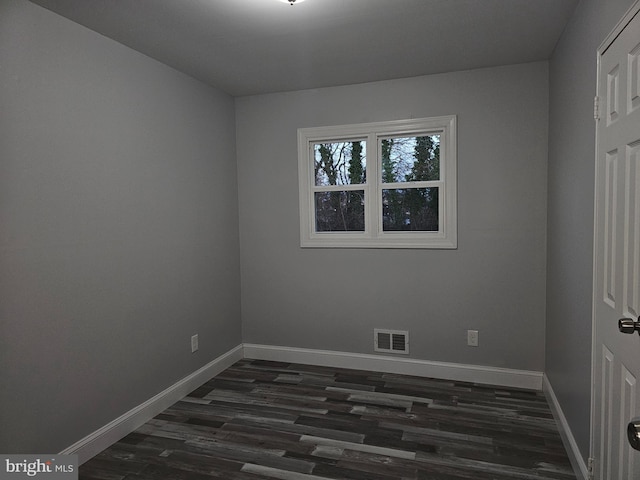 spare room featuring dark hardwood / wood-style floors