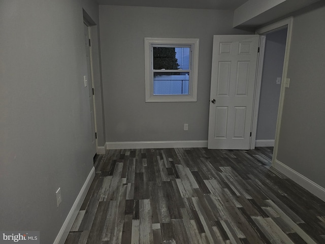 hallway with dark wood-type flooring