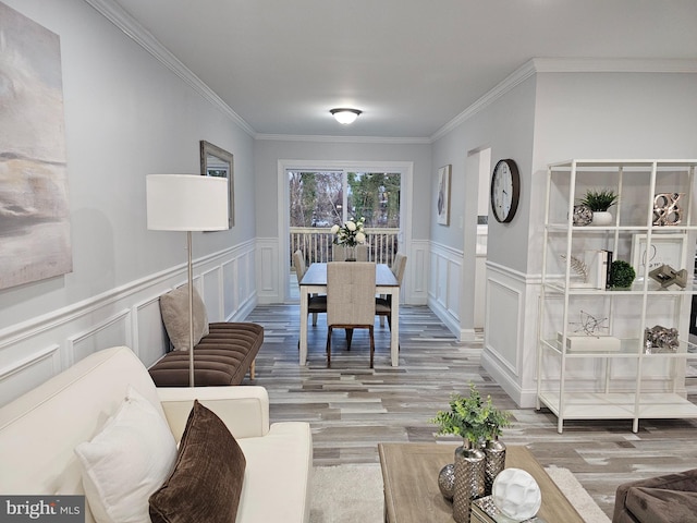 dining space featuring hardwood / wood-style floors and ornamental molding