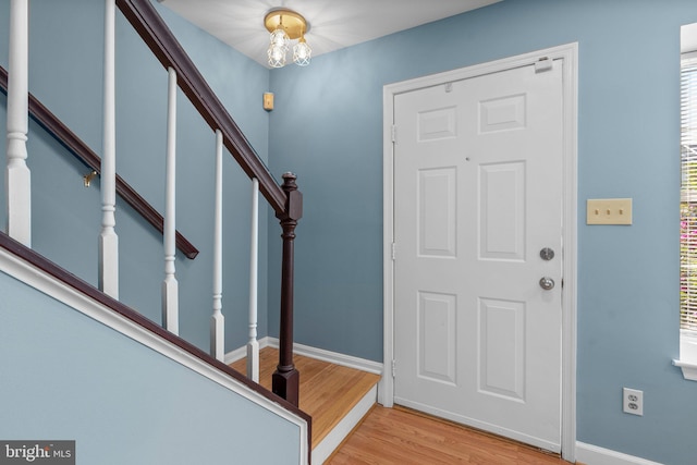 entrance foyer with a chandelier and light hardwood / wood-style floors