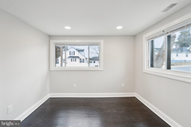 spare room featuring dark hardwood / wood-style flooring