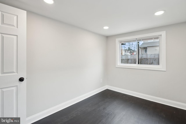 spare room with dark hardwood / wood-style floors