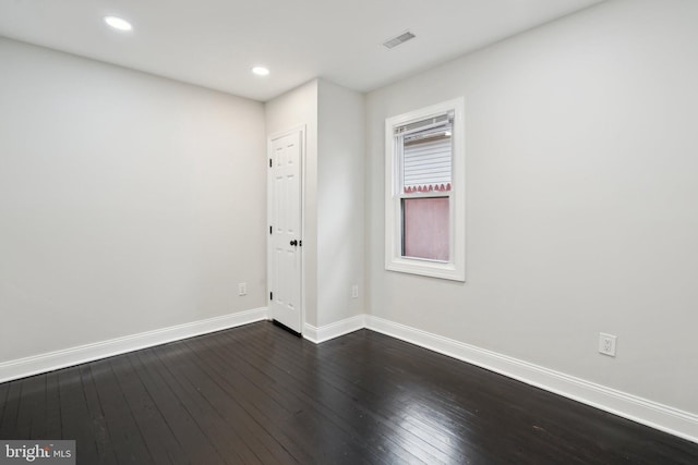 unfurnished room featuring dark hardwood / wood-style floors