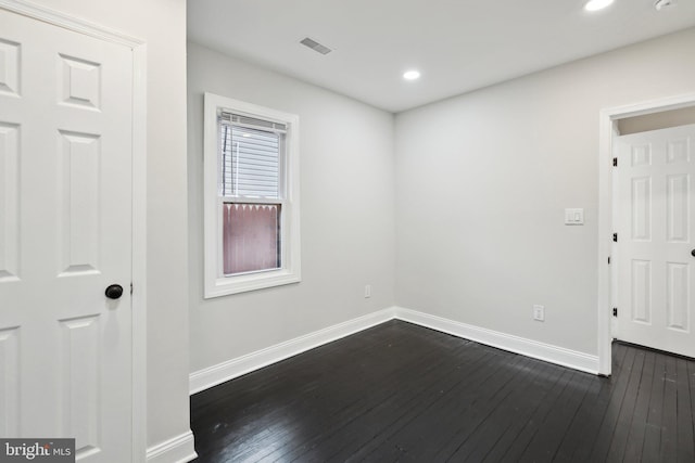 spare room featuring dark hardwood / wood-style flooring