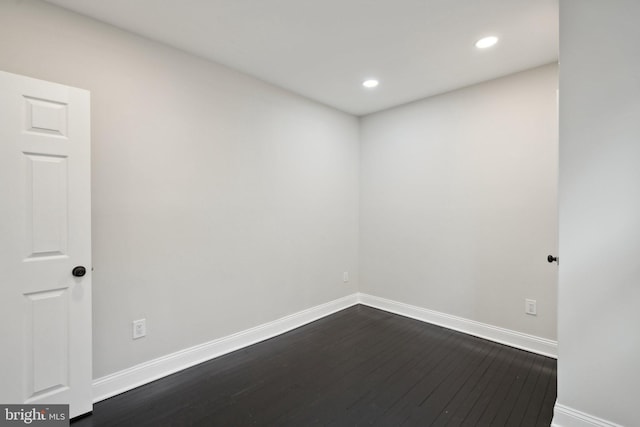 unfurnished room featuring dark hardwood / wood-style flooring