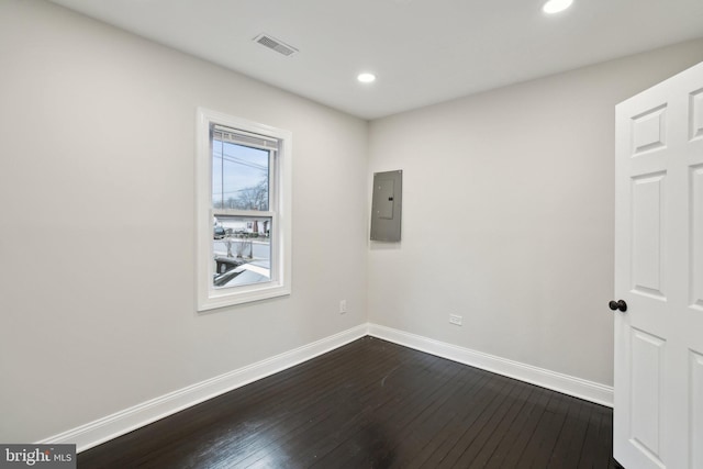 empty room featuring hardwood / wood-style floors and electric panel