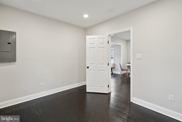 empty room featuring dark hardwood / wood-style floors and electric panel