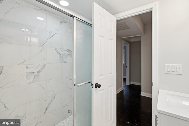 bathroom featuring vanity and a shower with shower door