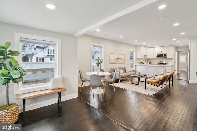 interior space featuring dark hardwood / wood-style flooring and beam ceiling